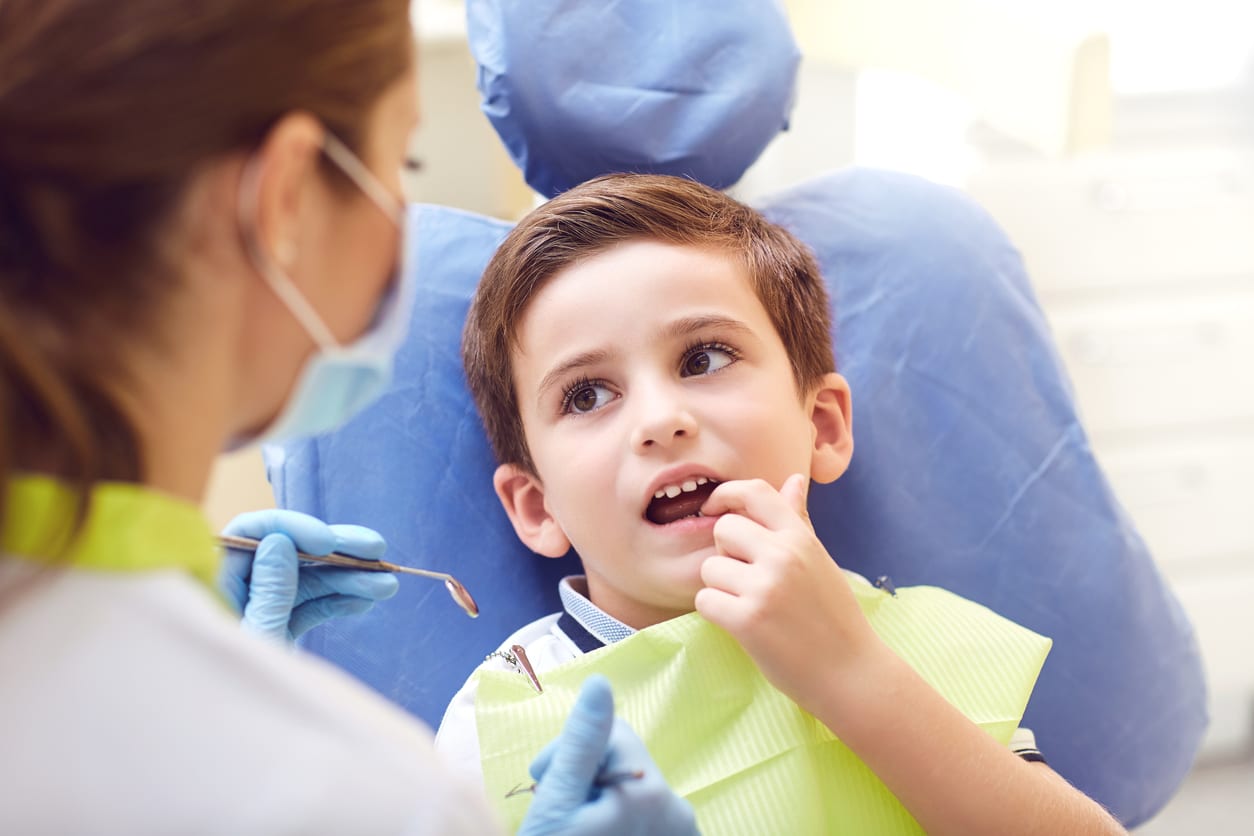 A child with a dentist in a dental office stock photo